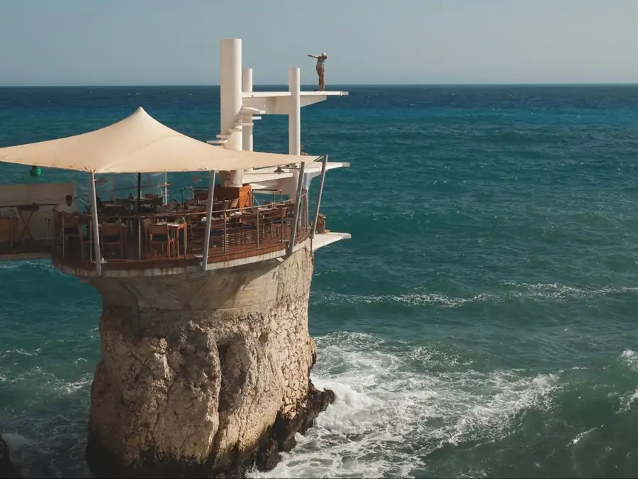 Cliffside restaurant terrace perched above the Mediterranean Sea in Nice