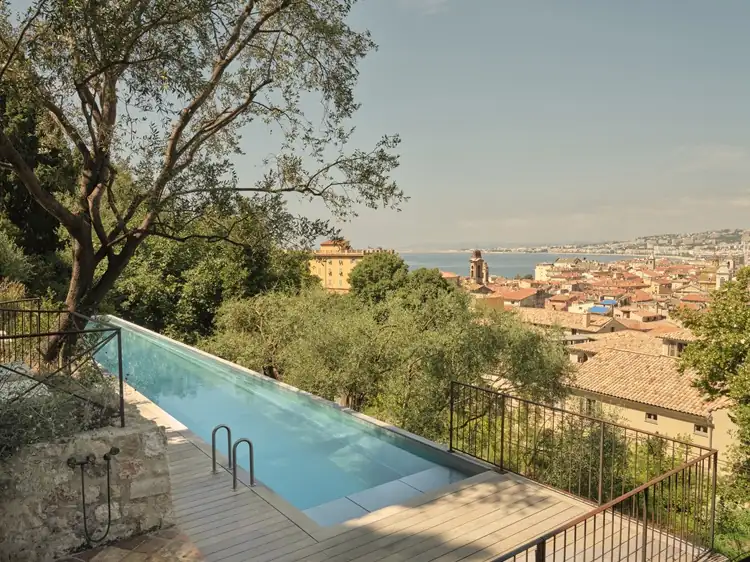 Hilltop infinity pool overlooking a Mediterranean village on the French Riviera