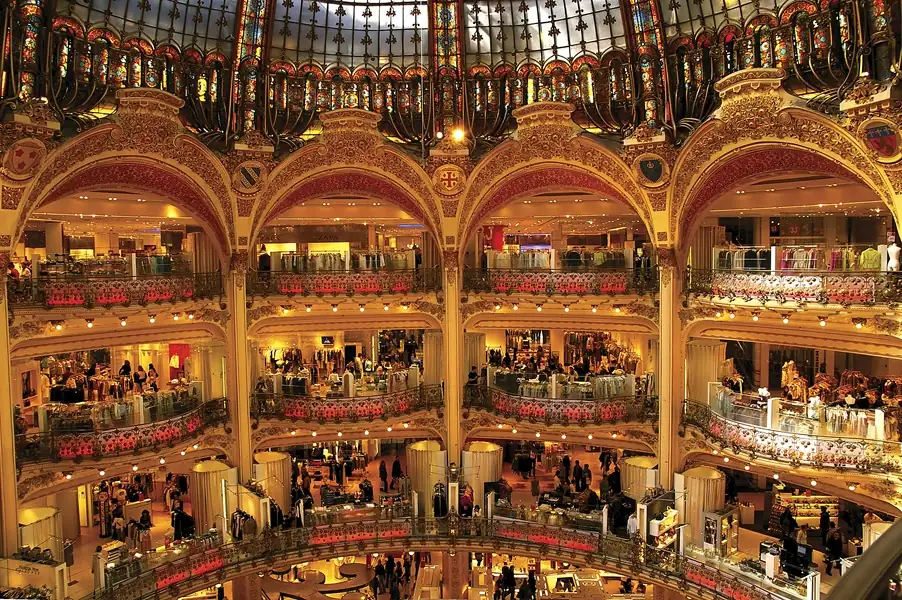 Iconic glass dome and balconies inside a historic Parisian department store, Galeries Lafayette.[memory:2]