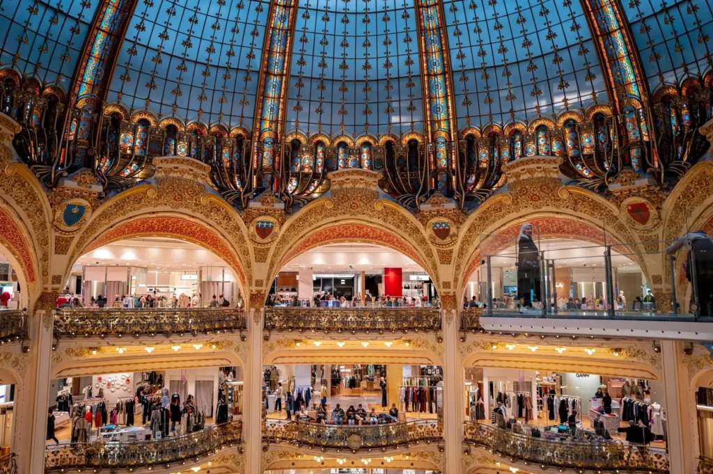 Stunning Belle Époque architecture inside Galeries Lafayette Paris with iconic glass dome and holiday decorations