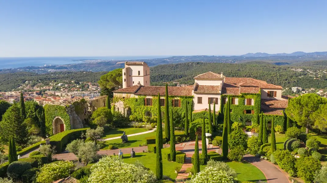 Grand Belle Époque facade of Hotel Metropole Monte-Carlo with ornate balconies and palm trees