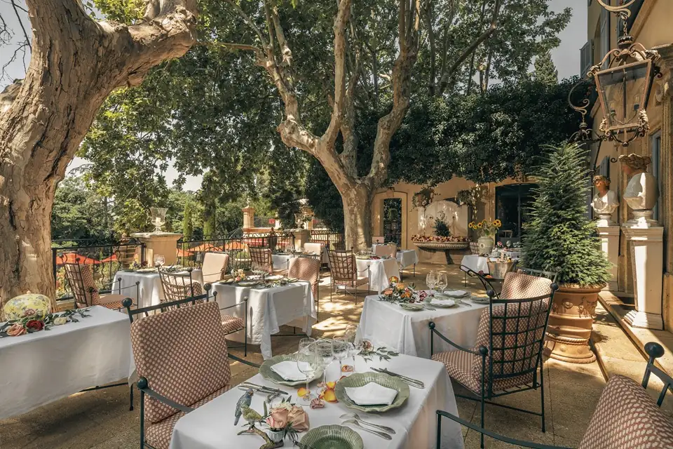 Elegant outdoor restaurant terrace with white umbrellas in Provence