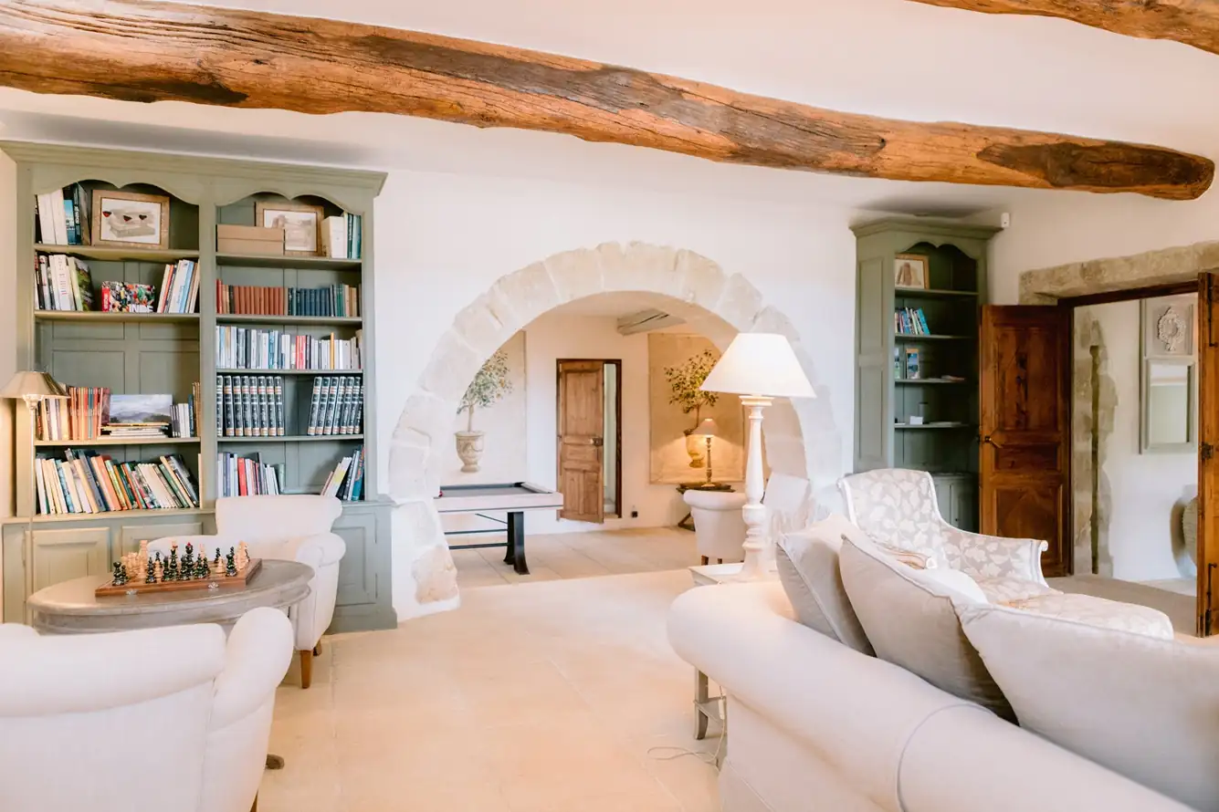 Bright and elegant luxury villa living room featuring a traditional stone archway and modern decor