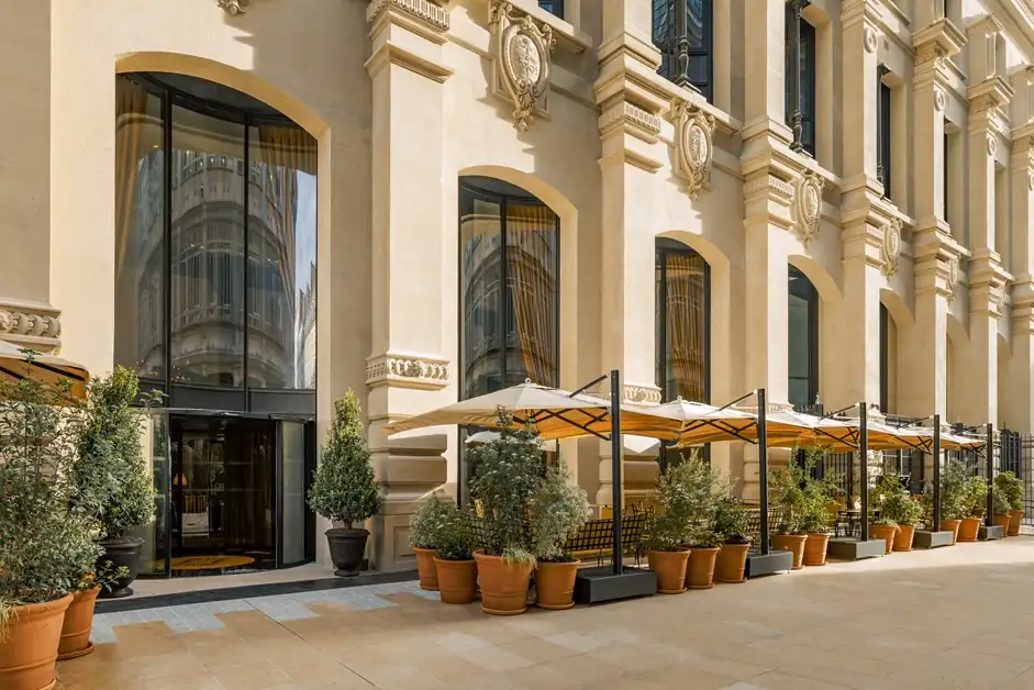 Elegant stone facade and entrance of Hotel Madame Reve, a luxury boutique hotel in Paris.