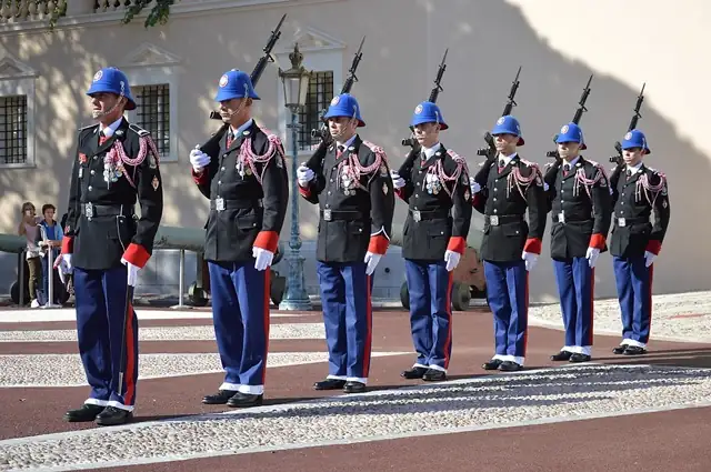 Elite palace guards in ceremonial white uniforms at Monaco royal residence
