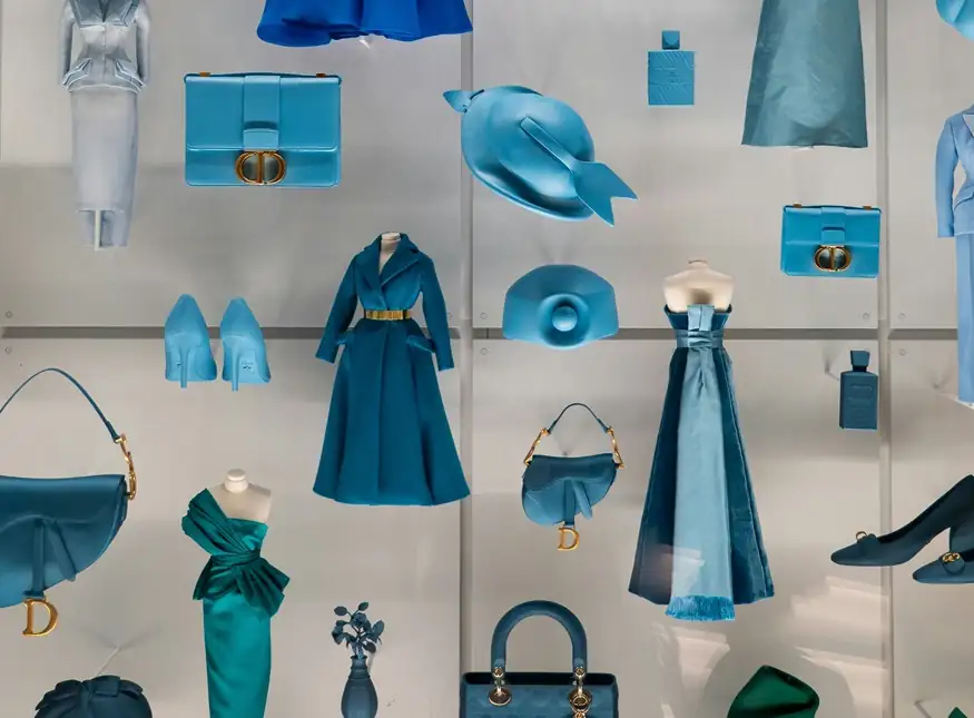 Curated blue-toned fashion and design objects styled in a Paris boutique window.[memory:2]