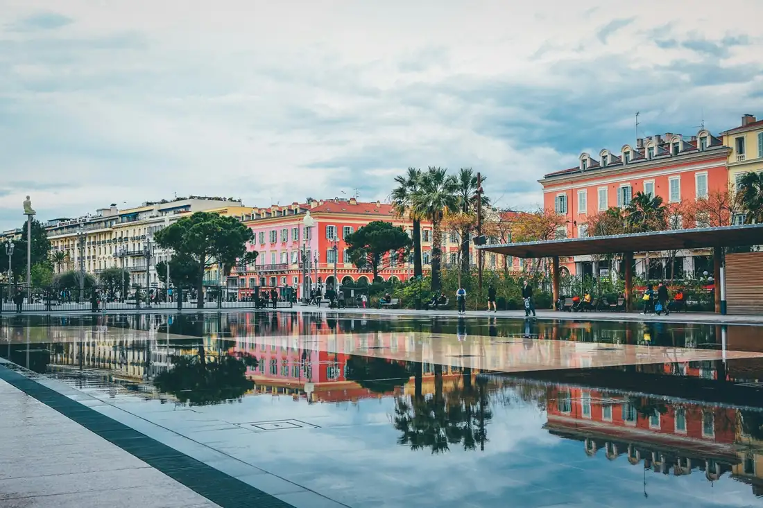 Pastel waterfront resort with reflection pool on the Côte d’Azur