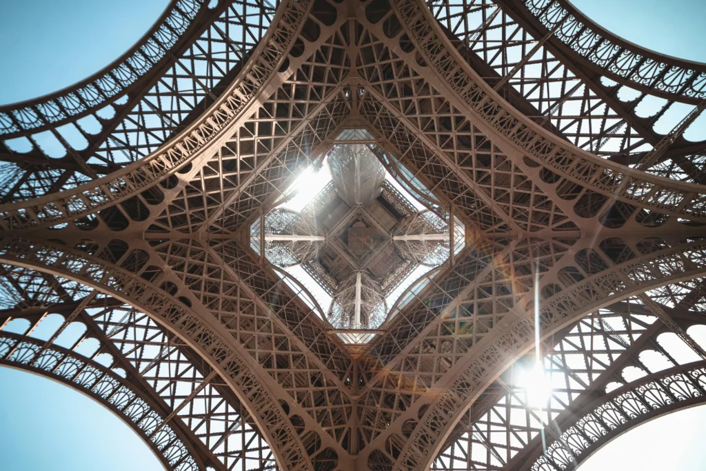 Sunlight shining through the Eiffel Tower latticework, looking straight up in Paris