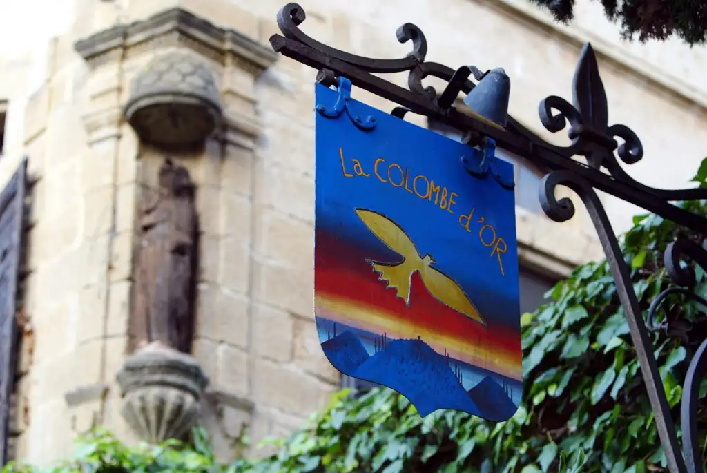 La Colombe d’Or sign hanging outside the legendary hotel and restaurant in Saint-Paul-de-Vence, France.
