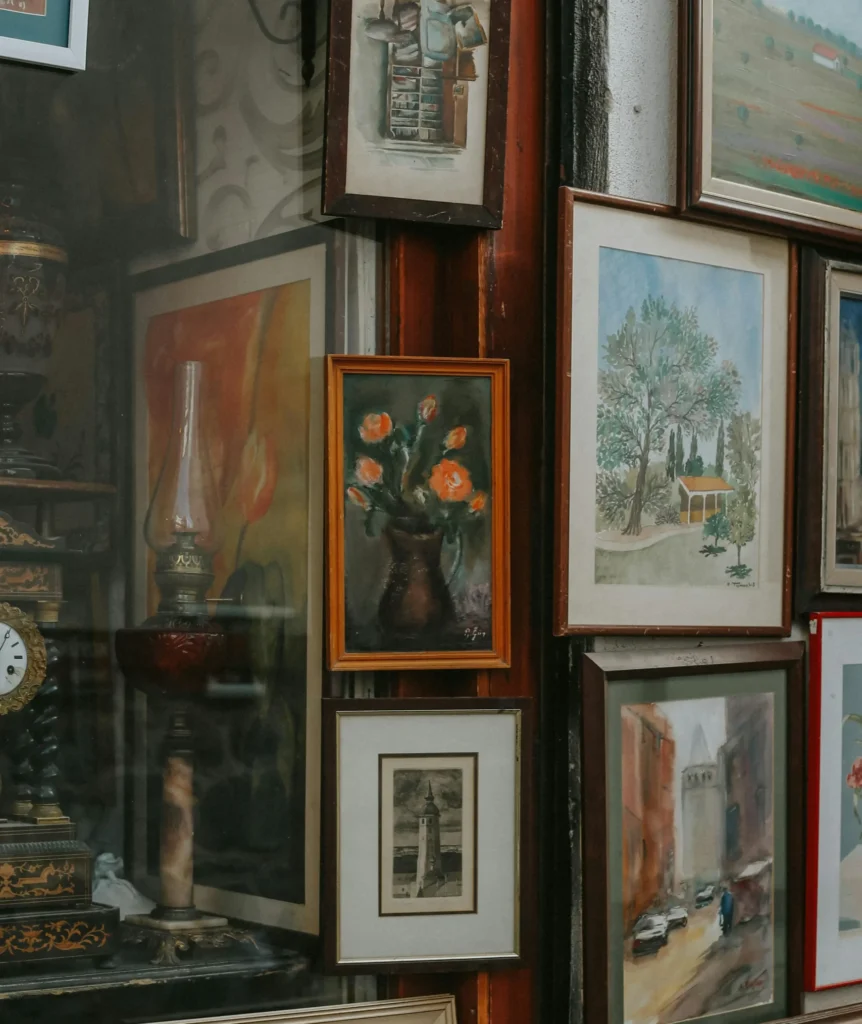 Art-filled gallery wall in Le Marais, Paris, showcasing eclectic framed artworks