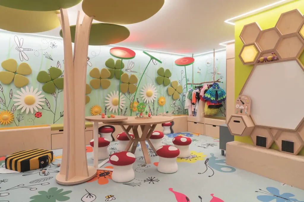 Kids clubs in France, Themed indoor kids club with mushroom stools and floral wall murals
