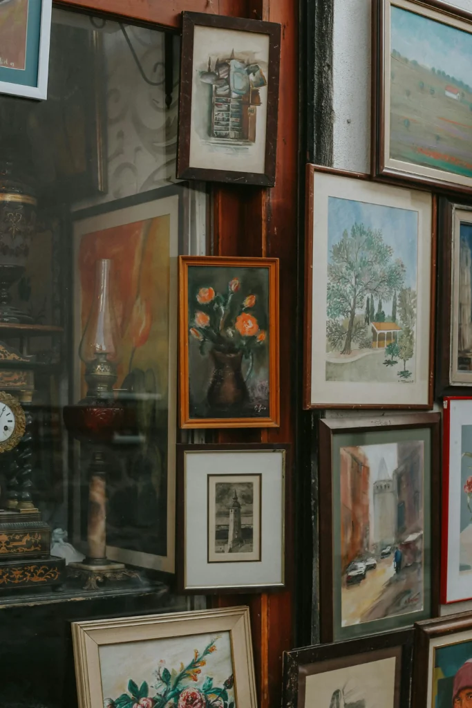 Paris antique market, Indoor antique market corridor with vintage framed artwork and furniture displays along covered passageway