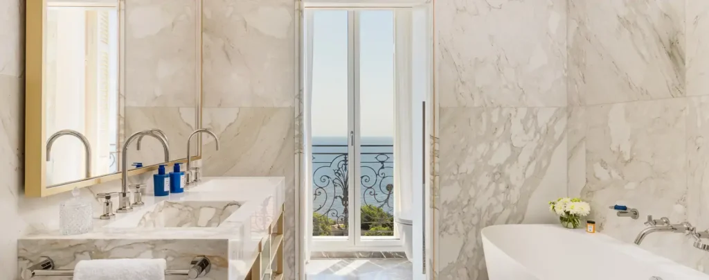 Luxurious marble bathroom with a soaking tub and stunning ocean views in a premium Monaco hotel suite