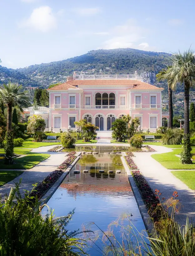 Villa Ephrussi de Rothschild, Pink Mediterranean villa with reflecting pool and mountain landscape backdrop