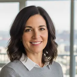 Professional travel consultant smiling warmly in modern office