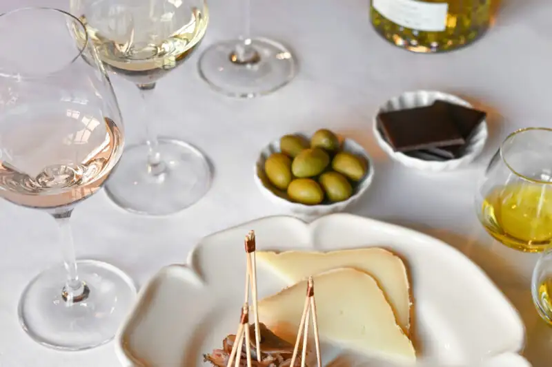 Wine Tasting in Provence, Close-up of French Provencal wine glass, creamy cheese and green olives appetizer