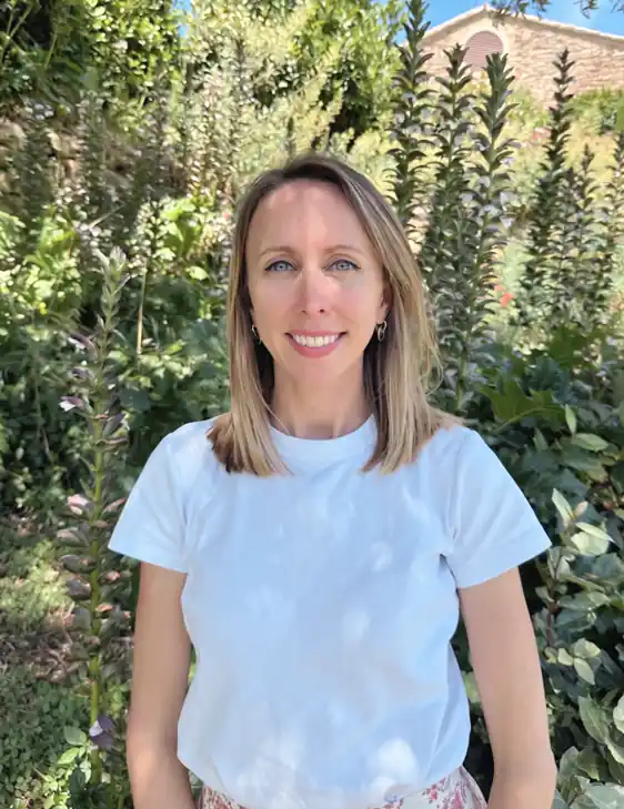 Olea Voyages luxury travel advisor smiling in a verdant Provence garden