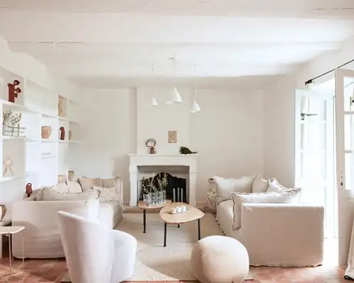Serene white lounge with plush sofas and fireplace at a luxury Provence retreat