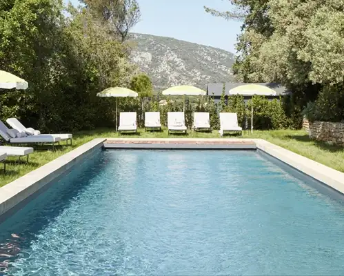 Tranquil outdoor swimming pool surrounded by greenery and Luberon scenery at a Provence retreat