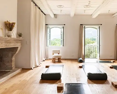 Bright, airy yoga and wellness studio with arched windows at a Provence retreat