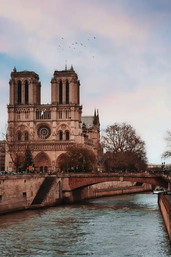 Planning a Paris trip, Notre-Dame Cathedral glowing at sunset along the Seine River in Paris