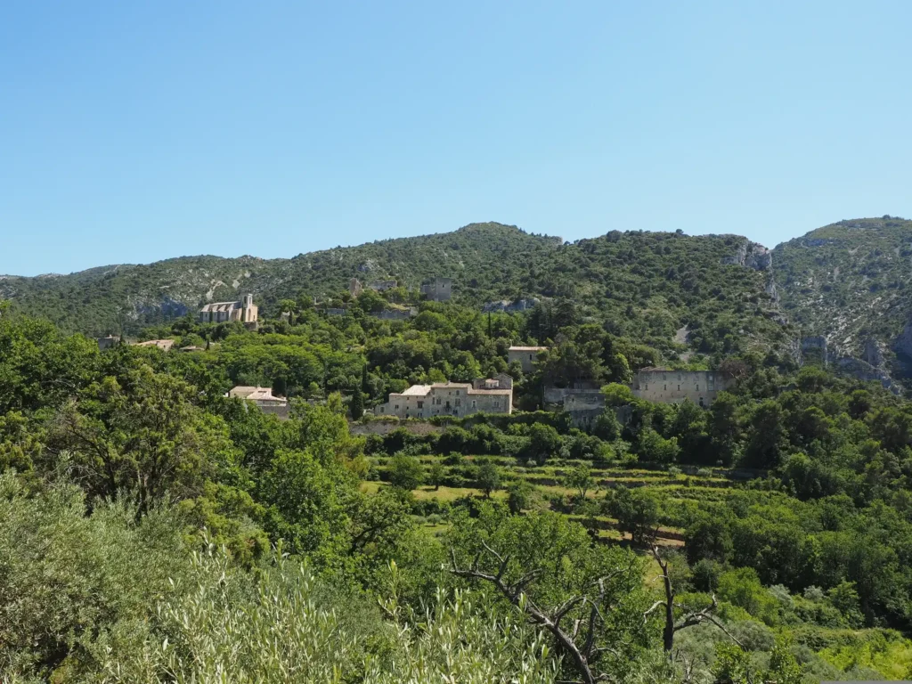 Planning a trip to France, Panoramic view of a Provence hillside village surrounded by lush green terraces